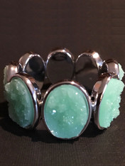 Make a dramatic statement with a large apple green druzy stretch bracelet set in stainless steel.  Affordable and impressive.  Stretches to 8"