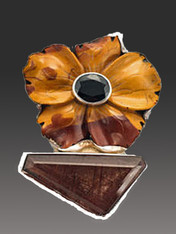 This magnificent Amy Kahn Russell pin/pendant is just gorgeous and beautifully crafted like her early works. It features a large hand-carved jasper flower with tones of wine, bronze, and brown in an intricate pattern with a large garnet cabochon set in sterling silver in the center.  The flower perches on a rutilated quartz asymmetrical stone all bezel set in thick sterling silver. 2-1/5" x 2"