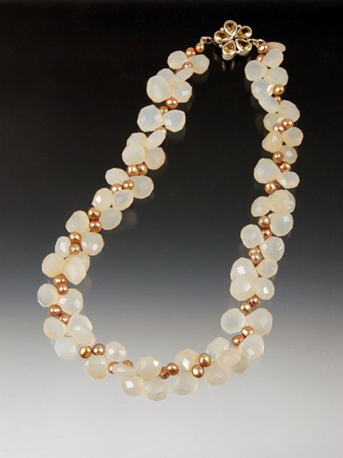 A collar of faceted pale yellow chalcedony plump teardrops spaced with luminous champagne freshwater pearls.  A custom sterling citrine flower clasp makes a charming center or side highlight.  