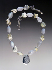 A gorgeous adjustable necklace of  raw pyrite,gray agate, and a Brazilian titanium pyrite druzy silver pendant.  