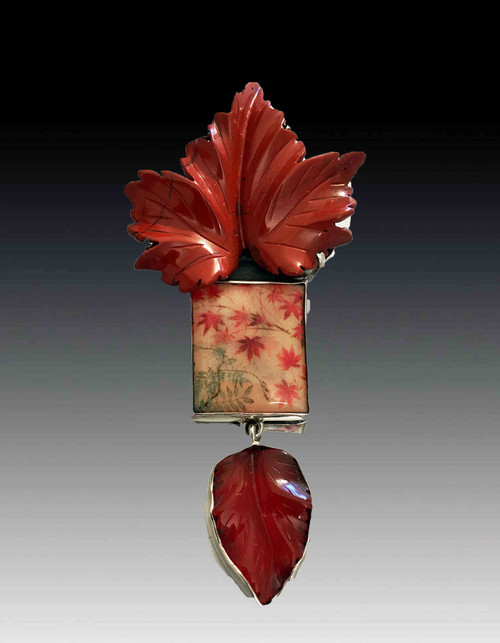 This stunning Amy Kahn Russell pin/pendant features an abstract handpainted tile set in high gloss resin with a hand-carved jasper leaf blossoming from the top and a carved dangle on the bottom set in sterling silver. Perfect for every season.  3' x 2'