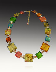 This extraordinary necklace is made of the most intricate rare Venetian glass beads known as "Machiavelli"  The Machiavelli line uses some of the richest and most colorful artistic Murano glass made in limited quantities.  Warm topaz, rubino and green tones are accented with gold foil and aventurina and formed into a cushion cut style.  Accented with Swarovski crystals and 24K plated findings, this showstopper is all you need to transform any outfit day or night.  20" with a 2" extender..  Very very limited.