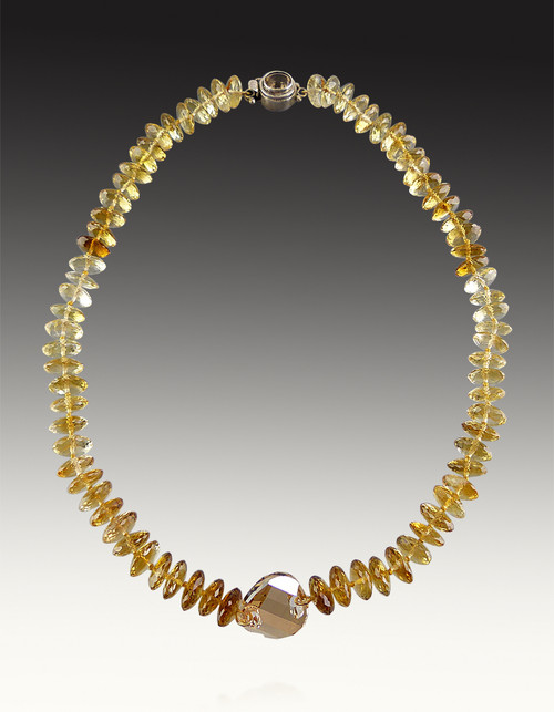  These luxurious shaded citrine German faceted rondelles have a stunning luster, superior polish and faceting that transforms each bead into brilliant transparent gems with hues ranging from pale yellow to a deep saturated Amber Yellow.  The center focal is a discontinued champagne faceted Swarovski disc with a citrine sterling clasp. 18" Only two!