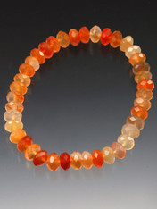 A delicate sparkling stretch bracelet of faceted carnelian rondels.  Wear alone or pair with others.