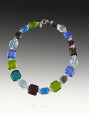 This cheerful collar of jewel-toned puffed Venetian glass in large and small square shaped spaced with discontinued Swarovski crystal "squaredells" and iridescent Swarovski crystals is perfect for any occasion and blends with many colors. Translucent and opaque blend beautifully. No two identical and very limited.  Perfect for the holidays. 18"