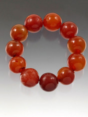 Rare and special grade AAA carnelian 16mm perfect round beads traditionally worn by men in China for "good luck". This gleaming dramatic stretch bracelet with oversize stones is just right for today's bold looks and colors and for any man or woman who wants "good luck"  Very Limited!