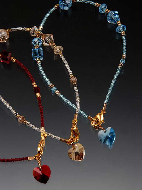 A dazzling token of love says a lot but costs a little.   Rich red Swarovski crytals, 24K vermeil cast toggle clasp,and a dangling Swarovski heart charm!  A perfect gift for Valentine or anytime. 7"-7-1/2" Choose red, London topaz blue, or light champagne.
