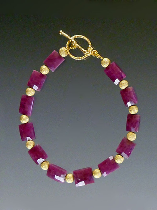 This magnificent ONE OF A KIND features perfectly matched faceted rubies spaced with 14K balls and a rare cast 14K clasp.  8" (length can be adjusted on request)