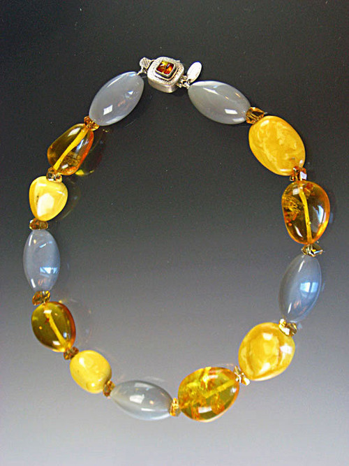 About 20 years ago I found a strand of huge precious baltic amber beads and now I've used them in this magnificent collar mixed with grey hexagon shaped moonstones and grade AAA faceted citrine.  This beautiful necklace features a vintage amber sterling clasp with safety hinge. 19-1/2"  