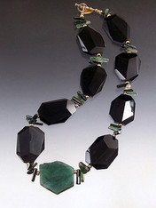 Remember when Angelina Jolie wore $2.5 million Brazilian emerald earrings to the Oscars? She was ahead of the curve because emerald green is the new hot color and Brazilian emeralds are the best. Many years ago I found a strand of Grade AAA natural Brazilian emerald slices. They aren't  polished gems like Jolie's but the real deal in their natural state and much more affordable. One 14 gram emerald slice is the centerpiece of a magnificent collar featuring faceted black onyx, green tourmaline,14K beads and clasp.  Each emerald slice is different and totally gorgeous. 