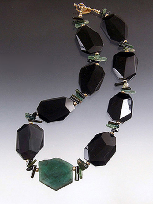 Remember when Angelina Jolie wore $2.5 million Brazilian emerald earrings to the Oscars? She was ahead of the curve because emerald green is the new hot color and Brazilian emeralds are the best. Many years ago I found a strand of Grade AAA natural Brazilian emerald slices. They aren't  polished gems like Jolie's but the real deal in their natural state and much more affordable. One 14 gram emerald slice is the centerpiece of a magnificent collar featuring faceted black onyx, green tourmaline,14K beads and clasp.  Each emerald slice is different and totally gorgeous. 