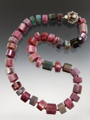 SO RARE AND SO FABULOUS! This strand of grade AAA trillion cut Brazilian strawberry tourmaline features amazing colors, Japanese double hand-knots in silk and a custom mabe pearl sterling  clasp. 18"  