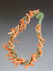 Feel like a mermaid in this whimsical torsade of genuine branch coral, grade AAA round coral, green jade and pearls held with a dramatic hand-carved jade seahorse side clasp all on pale peach silk thread.  19"  