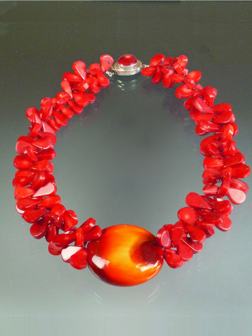 If you want to make a WOW dramatic statement, this dazzling creation is for you.  Huge tomato red coral florets frame a one of a kind 2-1/2" glazed Venetian Glass Disc (snagged at a trade show many years ago waiting for the right opportunity and setting) with a sunburst pattern of deep red, orange and gold . A red coral sterling 1" custom clasp completes the design. Picture this on bright white, black, or the new bold tones of the season. Total length 22"  