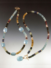 Yin and Yang - two stunning collars with different patterns but the same grade AA elements. The first features precious faceted tourmaline, citrine, and aquamarine and 14K fluted rondels with faceted aquamarine stations.  The second features an entire collar of the same precious gemstones and 14K rondels with a large faceted aquamarine dangle.  The limited edition swirl toggle clasp is solid cast 14K original price now!  ONLY ONE OF EACH!