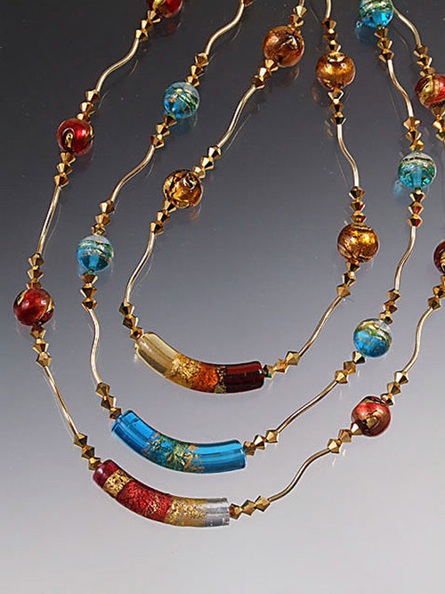 The perfect holiday gift to wear all year long! Circle your neck with 17" of  glittering gold -- sparkling 24K Venetian glass framed with 24K gold-plated Swarovski crystals and 14K tubes and toggle. Light as a feather and totally dazzling!   Choose cobalt/peridot, aqua/gold, garnet/gold, topaz/gold.