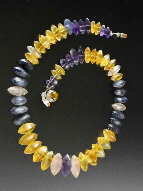 If you like subtle luxury and something you won't see on anyone else, this is for you.  This wonderful collar features dimensional grade AAA matte finish iolite, amethyst and citrine  with two sets of holes that make it fit like a Grecian collar.  This one is 17" and features an amber sterling clasp.  