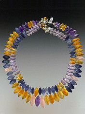 If you like subtle luxury and something you won't see on anyone else, this is for you.  This wonderful collar features dimensional grade AAA matte finish iolite, amethyst and citrine  with two sets of holes that make it fit like a Grecian collar.  These are 18" and 19" and featurs an amber sterling clasp.  No two alike but equally stunning