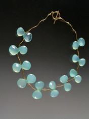 Flowering vines of grade AAA aqua chalcedony clusters are suspended between 14K curved branches and a 14K toggle clasp. 18"