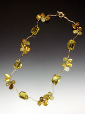Like a delicate green-gold vine, this charming 17" collar of perfect lemon topaz stones is spaced with 14K branches and precious clusters of green garnet, peridot and gold petal pearls with a 14K toggle clasp.  NOTE: Can be special ordered with less karat weight for lower price. inquire by email.