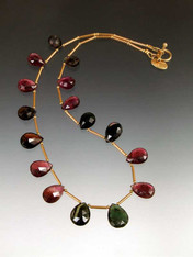 This luxurious collar features Grade AAA faceted tourmaline teardrops from deep green to strawberry to pale cognac with 18K stations and toggle clasp.  (Note: Contact us for availablity of less karat weight at a lower price)