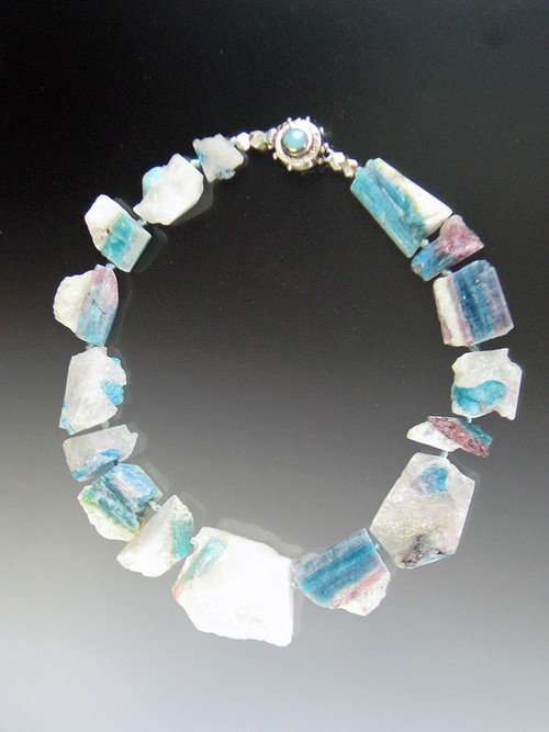 If you appreciate rare natural wonders, you will grab this amazing natural Brazilian Paraiba Tourmaline* necklace spaced with Japanese double silk knots and finished with a custom peruvian opal sterling clasp.17"  I bought this many years ago from a Brazilian rare gem specialist not knowing exactly what it was but enthralled by the raw beauty of it.  I have since learned that Paraiba tourmaline in its polished form is one of the most valuable gemstones in the world, selling for over $10,000 a karat. 