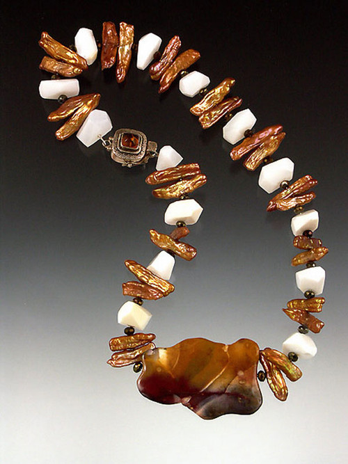 A spectacular explosion of pink, purple, butterscotch and sienna tones swirl in this unique 20" necklace featuring a 2" Australian moukaite wave slice surrounded by white opal cut nuggets, bronze biwa pearls and a sterling amber clasp. 
