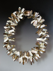 Want to look as powerful as Elizabeth I?  Want to make a statement with a suit or evening gown? You don't need a fluted  "ruff" standing 3" around your neck. Just don this dimensional collar of intertwined bronze and white  biwa pearls spaced with sparkling tiny Swarovski crystals and a Peruvian mabe pearl sterling clasp for a fabulous effect.   20"