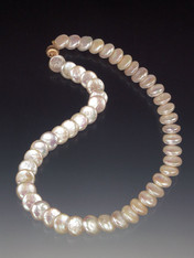 New Twist on the Classic String of Pearls!... High-luster perfectly matched white coin pearls with a 14K ball clasp that can be worn as a side or center highlight.  17"