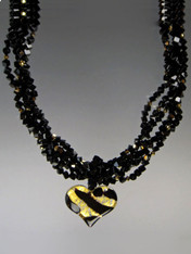 Two opulent looks in one! Luxuriate in four strands of Grade AAA onyx dice spaced with 24K plated genuine Swarovski crystals.  A dramatic Venetian glass freeform black and gold tiger pattern heart suspended from a circle of onyx beads can be removed for an elegant torsade only look.18" (Longer lengths available on request)