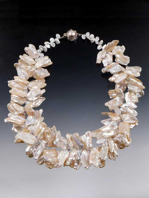 WOW!  If you love pearls, if you love drama and opulence, this is it! Perfect for a wedding or opening night gala. Several years ago I found two strands of these incredibly luminous freeform pearls, one in pale blossom pink, the other silver white.  Each pearl is HUGE -some almost 2" This looks like a double strand but it's actually one strand.  Tiny Swarovski crystal stations give it an extra sparkle and a pearl sterling clasp complete the picture.  19"  Choose pale blossom or silver white (not pictured).