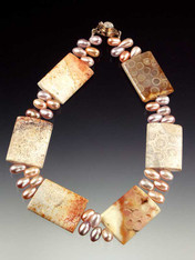 Fascinating to see in person and flattering to wear!  An 18" collar of fossilized coral rectangles -- each with intricate patterns formed over many years-- framed by lustrous blush-toned freshwater pearls.  Each piece unique!