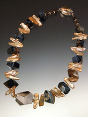 A huge faceted Brazilian topaz is the dramatic focal point for a stunning collar of Grade AAA rare South African Pietersite (filled with natural patterns of black, blue, gray, and brown) spaced w champagne biwa pearls and 14.  17"  ONLY TWO!