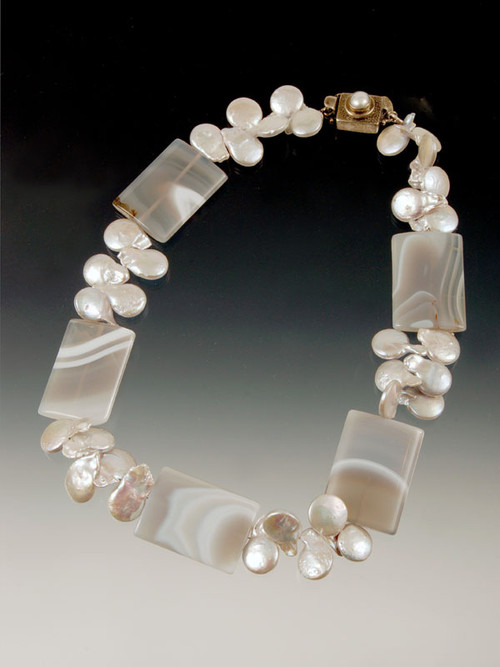 A striking collar featuring elaborately patterned gray agate slices spaced with silver pearls --super cool!