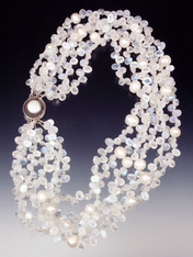 Want a collar of white diamonds? These are just as dazzling and more interesting! 14mm white pearls float on clouds of faceted rainbow moonstone with flashes of blue and white ice.  Superb quality. Only three or four strands available. 20"