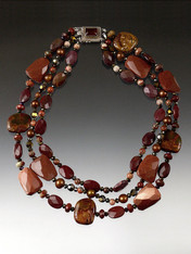 An absolute showstopper.  This torsade features a random mix of goldstone, Australian and other jaspers, with copper Swarovski crystals and a custom Pietersite sterling clasp custom made in Peru.  A beauty to wear in many ways. Longest strand 21"