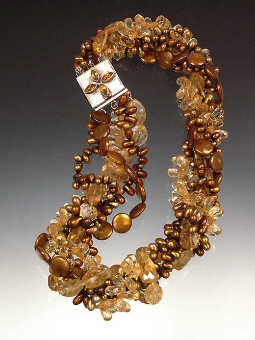 An all time bestseller and total showstopper. This magnificent torsade features several shades and shapes of citrine and gold/bronze pearls with a citrine sterling highlight clasp.  20"