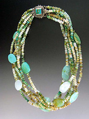 This stunning torsade features six strands of multi-toned Peruvian opal rondels spaced with Peruvian Opal faceted slices and a custom clasp of turquoise set in a patterned sterling silver clasp with two safety catches. 18" flat.