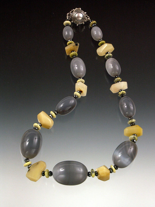 A must-have for mineral lovers! And the latest color combo. featuring luminous smooth gray moonstone ovals, honey opal cut nuggets, lemon chrysophrase rondels, and a luxurious mabe pearl sterling clasp. 19.5"