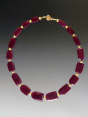 Absolutely collectible, and fit for a queen!  Perfectly matched deep red horseshoe shaped raw rubies spaced with laser-cut 14K gold beads and a 14K clasp.  17"