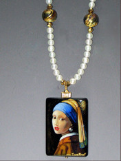 The Girl with the Pearl -  This hand-painted lacquered miniature features a radiant recreation of this famous image underlit with luminous gold 24K foil. A black onyx pendant  crowned with a 14K fluted rondel and 24K Swarovski crystal.