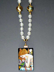 Featuring a hand-painted Lacquered miniature is a portrait by the renowned late 19th Century Art Nouveau painter, Alphonse Mucha.  The pendant, crowned with a 14K gold rondel and 24K Swarovski crystal.  18"

 
