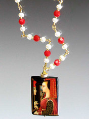 This one of a kind pendant features a famous Flemish painting of two lovers confessing their affection.  The pendant is handpainted with 24K gold overlay and the chain is linked pearls and red coral.  24"