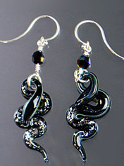 These sparkling dramatic earrings feature silver and black Venetian glass serpents, Swarovski crystals and sterling silver earwires. 