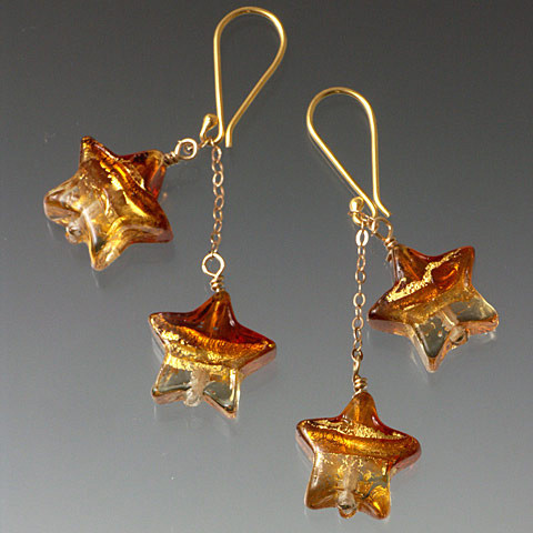 These charming double dangle earrings feature topaz and gold 24K Venetian glass stars with 18K chain and earwires.  ONLY ONE PAIR LEFT!!

 