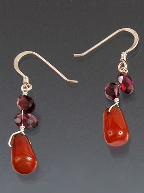 This very popular affordable design is easy to wear with everything while adding a touch of sparkle.  It features carnelian dangles topped with faceted rhodolite garnet and sterling silver earwires. 1"