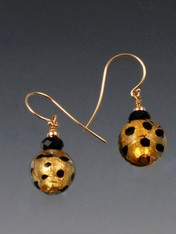These earrings feature topaz-gold spotted Venetian glass balls with Swarovski crystals. 