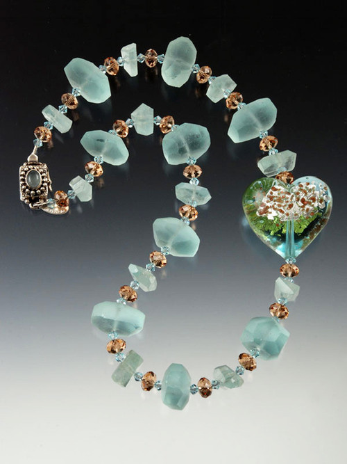 A magnificent transparent azure Venetian glass heart with clouds of 24K and sterling silver floats on a strand of  rare matte aquamarine nuggets, grade AA finely faceted aquamarine, and cognac Swarovski crystals. Get two looks in one by reversing the heart!  19"   Last one!