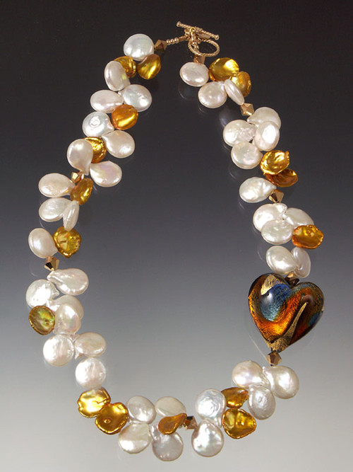 This luxurious elegant and dramatic necklace features a 1-1/4" puffed heart of 24K gold blue, orange and garnet evoking a gorgeous sunrise held by opulent white pearls and huge gold petal pearls, Swarovski crystals.18"