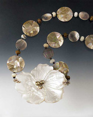This statement necklace  features alternating mosaic shell and mother of pearl discs and mocha opal rondels.  20"